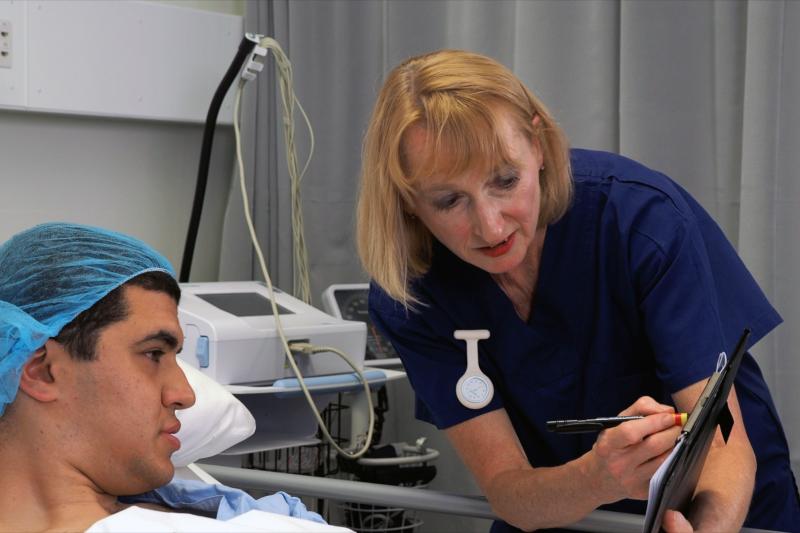 A nurse helps a patient